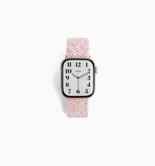 A pink cloud nylon Apple Watch band with a pattern, displayed on a white background.