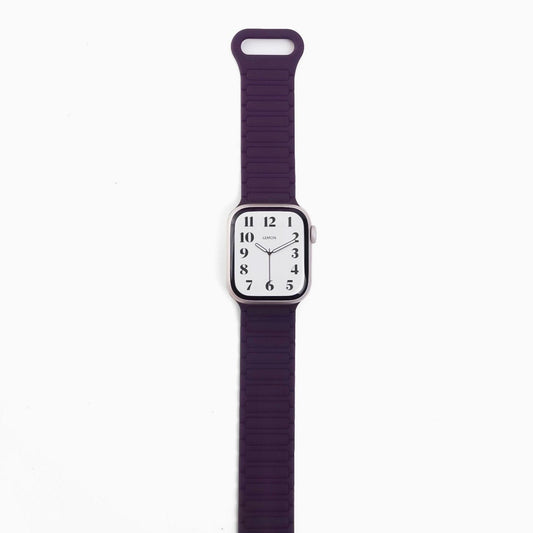 A purple silicone band for an Apple Watch with a magnetic loop attachment.