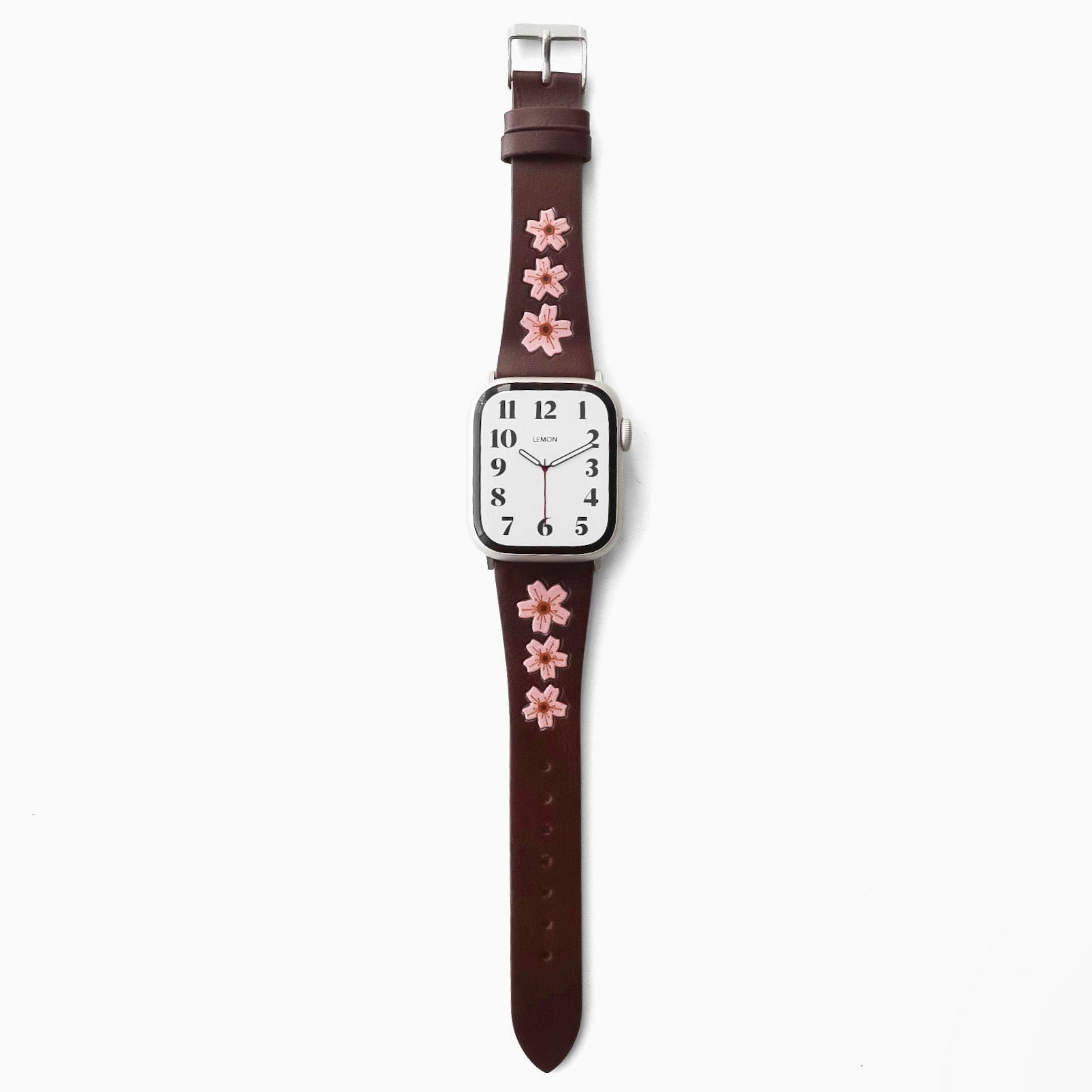 Watch with a brown strap featuring pink floral designs