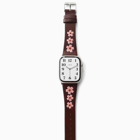 apple Watch with a brown strap featuring pink sakura