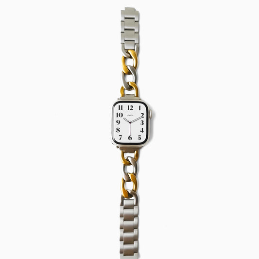 Wristwatch with a silver and gold metal band on a white background