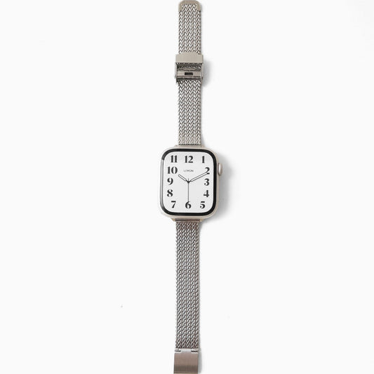Silver watch with a mesh band on a white background