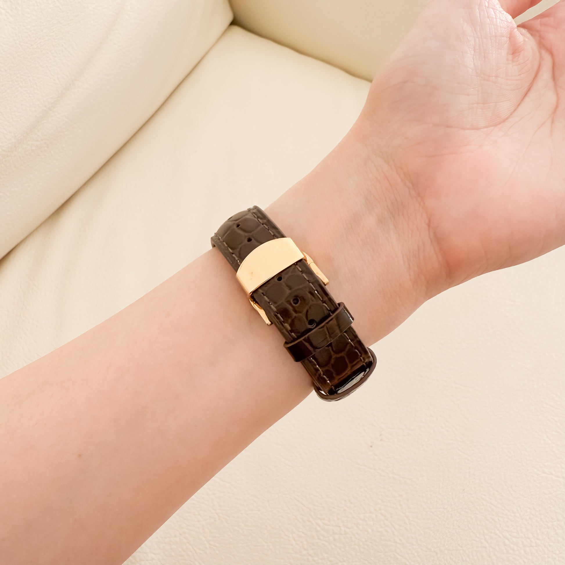 Brown crocodile-patterned APPLE  watch strap on a wrist