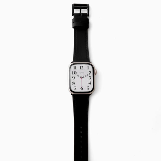 A black leather Apple Watch band with a smooth finish and a classic buckle clasp.