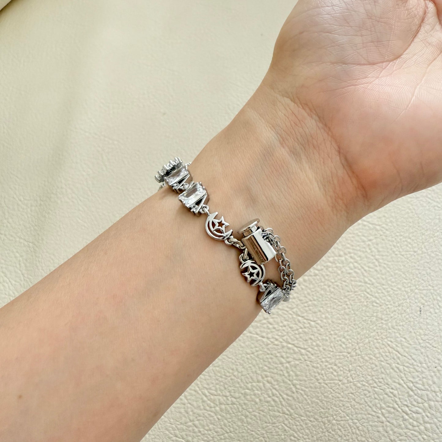 Silver apple watch bracelet with a decorative charm 34