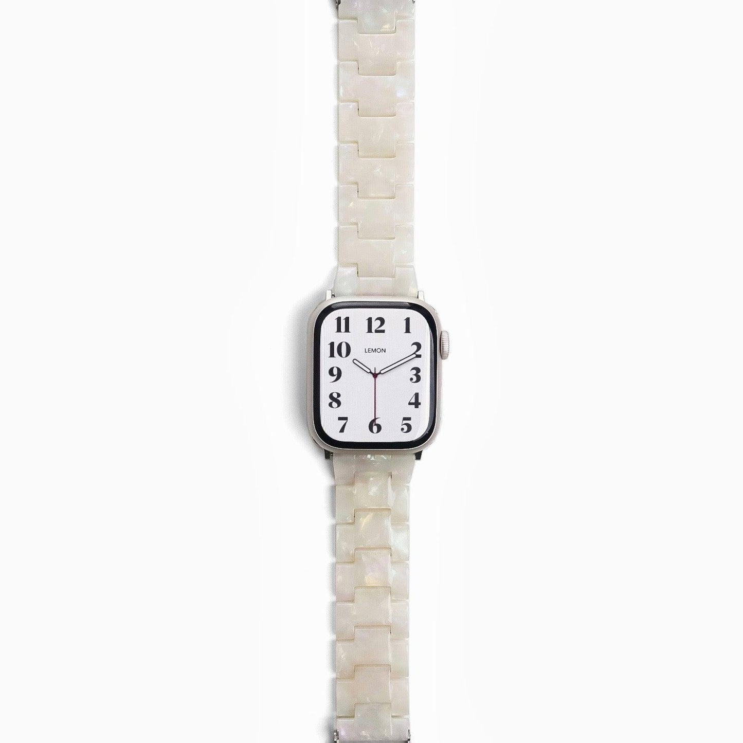 A pearl white resin band for Apple Watch, displayed on a watch with a silver case.