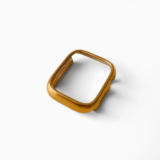 A gold-colored Apple Watch bumper designed to protect the watch screen.