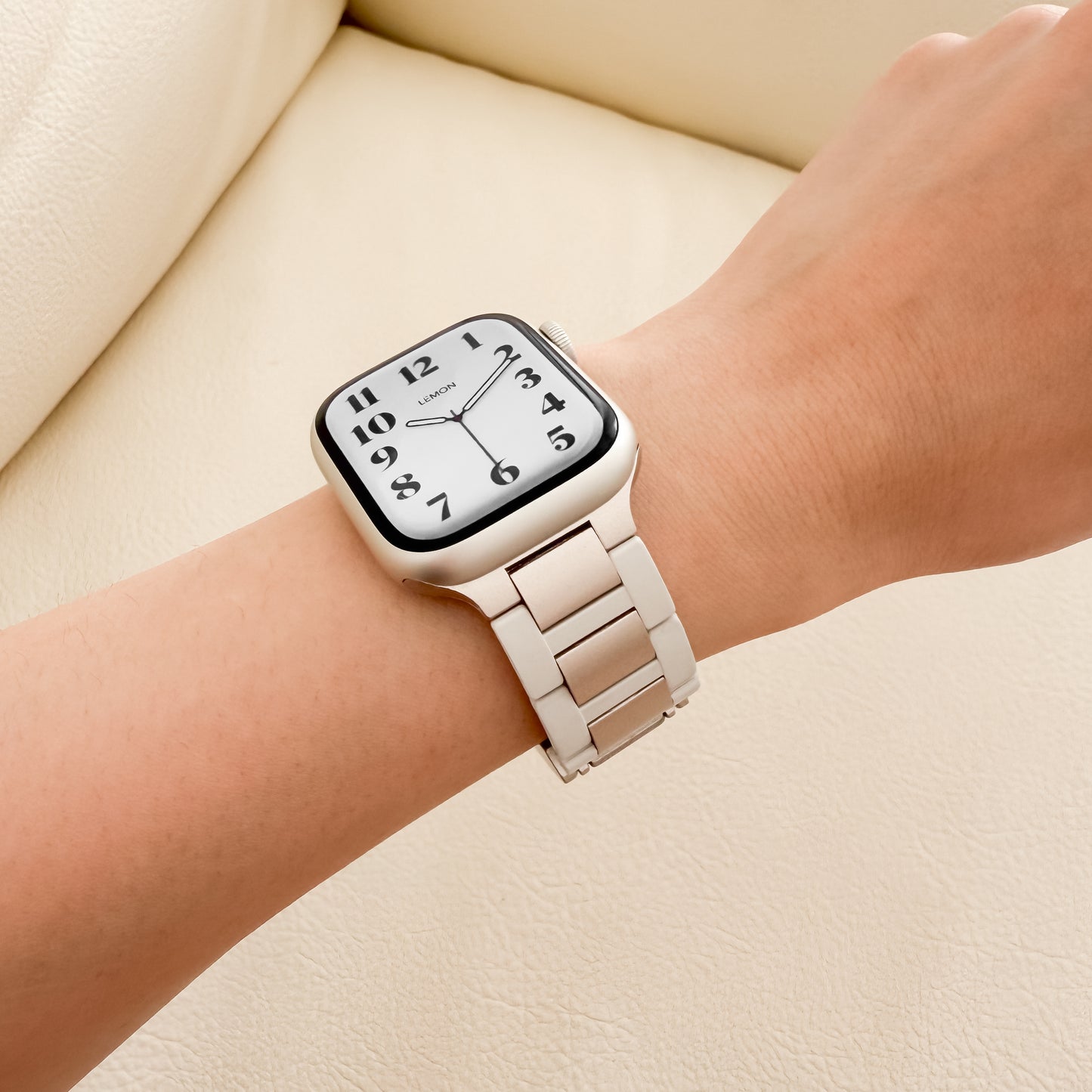 Wrist wearing a STARLIGHT APPLE WATCH watch 