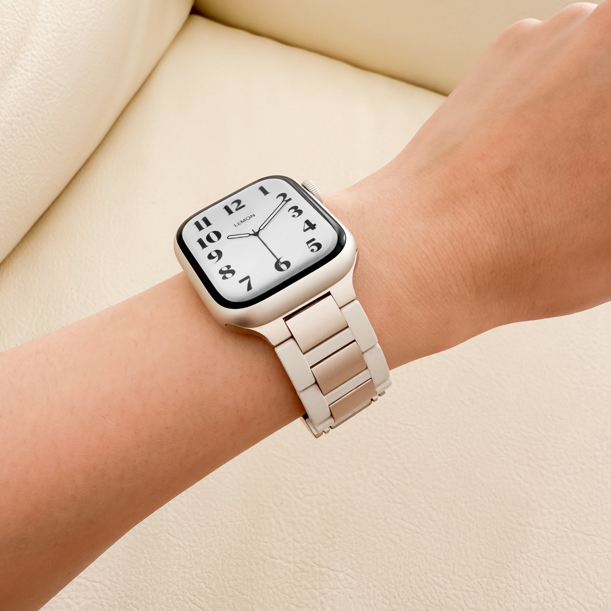 Wrist wearing a STARLIGHT APPLE WATCH watch 