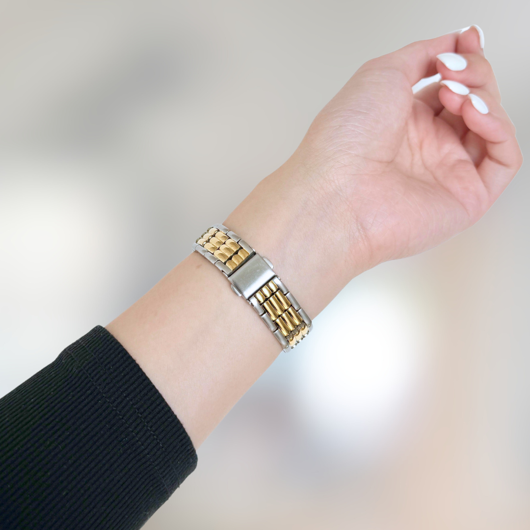 wearing a gold and silver bracelet for apple watch