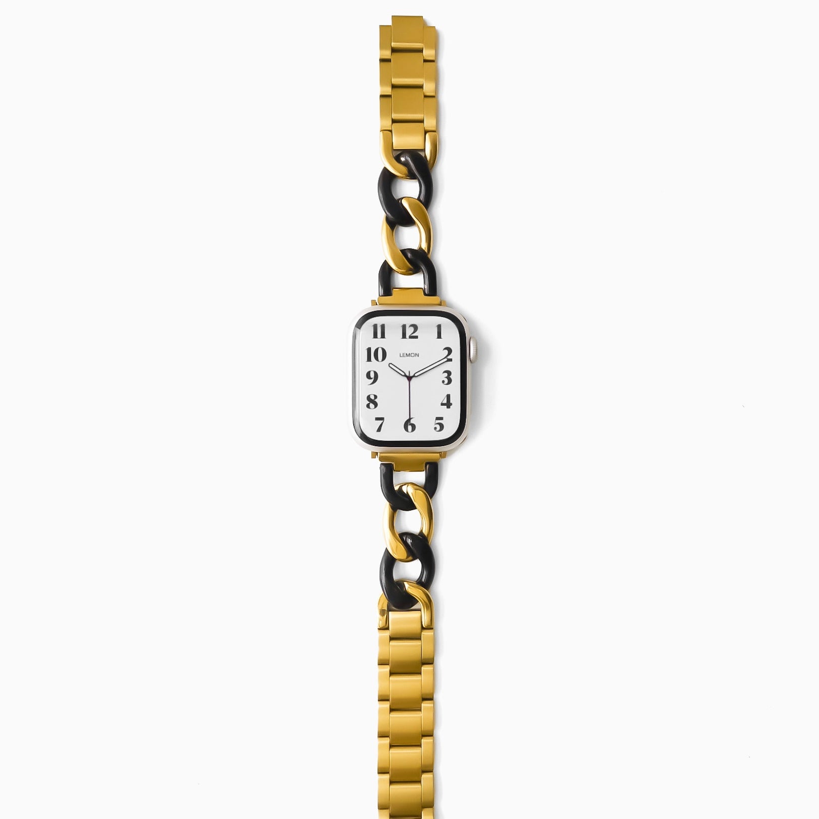 Gold and black watch with a white face on a white background