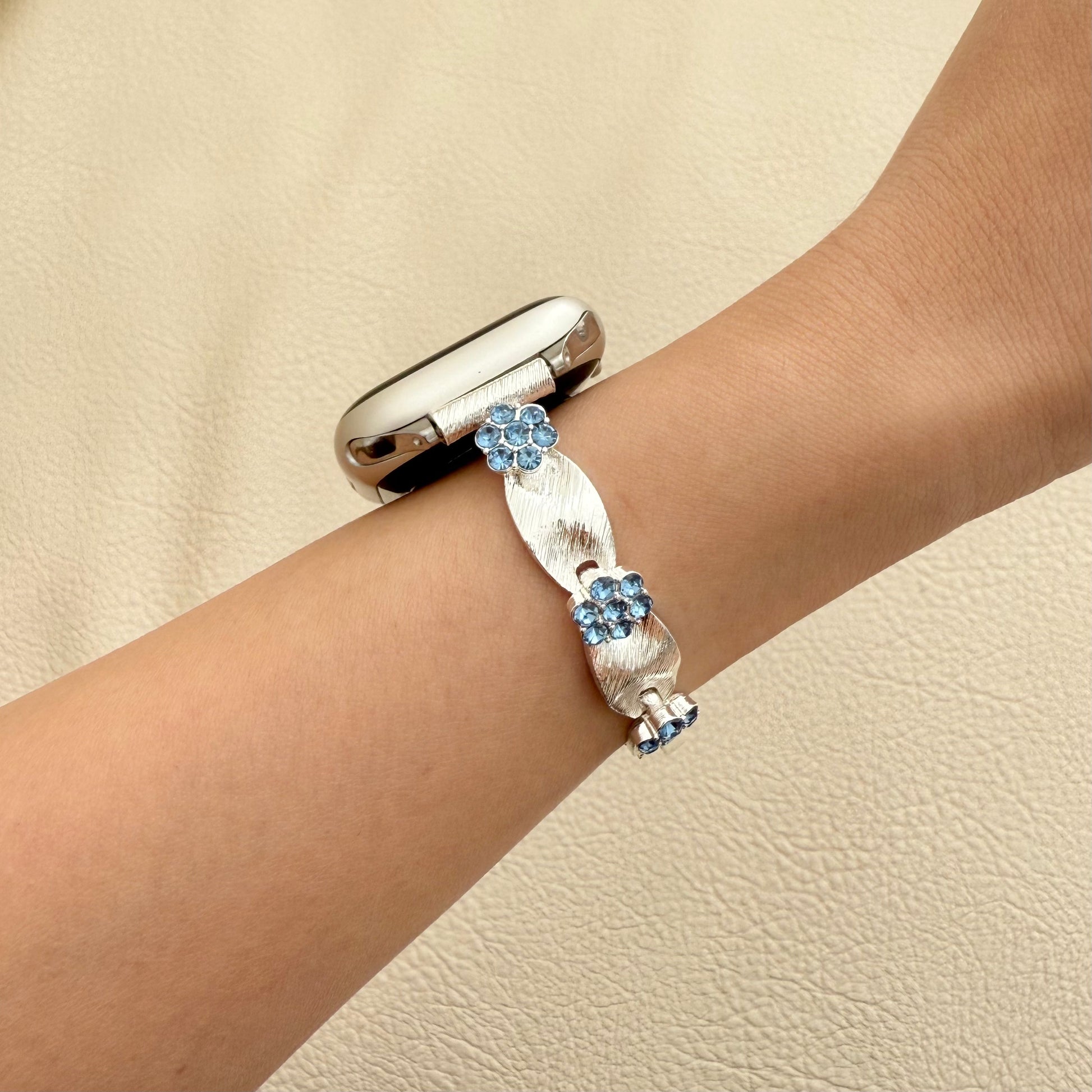 Silver APPLE WATCH bracelet with blue gemstones on a wrist 