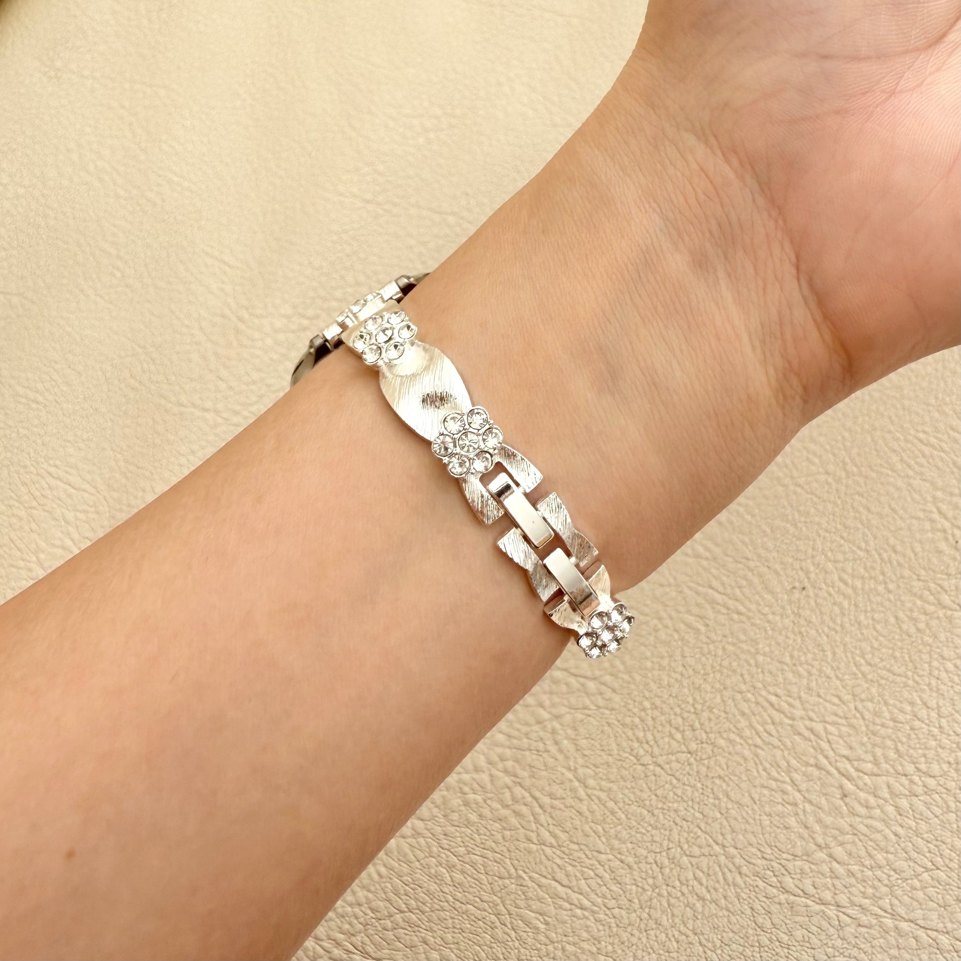 Silver APPLE WATCH  bracelet with a diamond on a wrist 