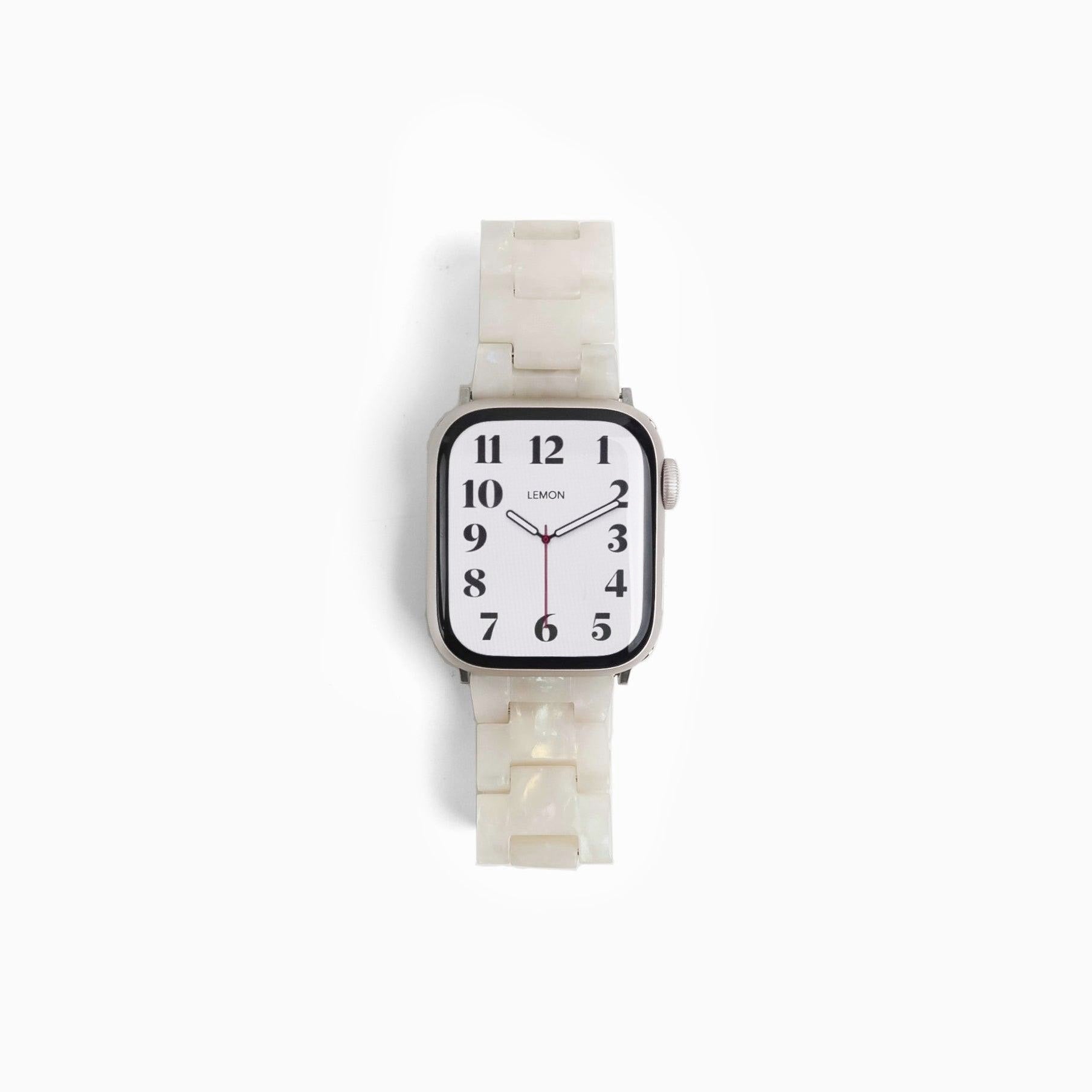 Wristwatch with a white strap and face on a white background