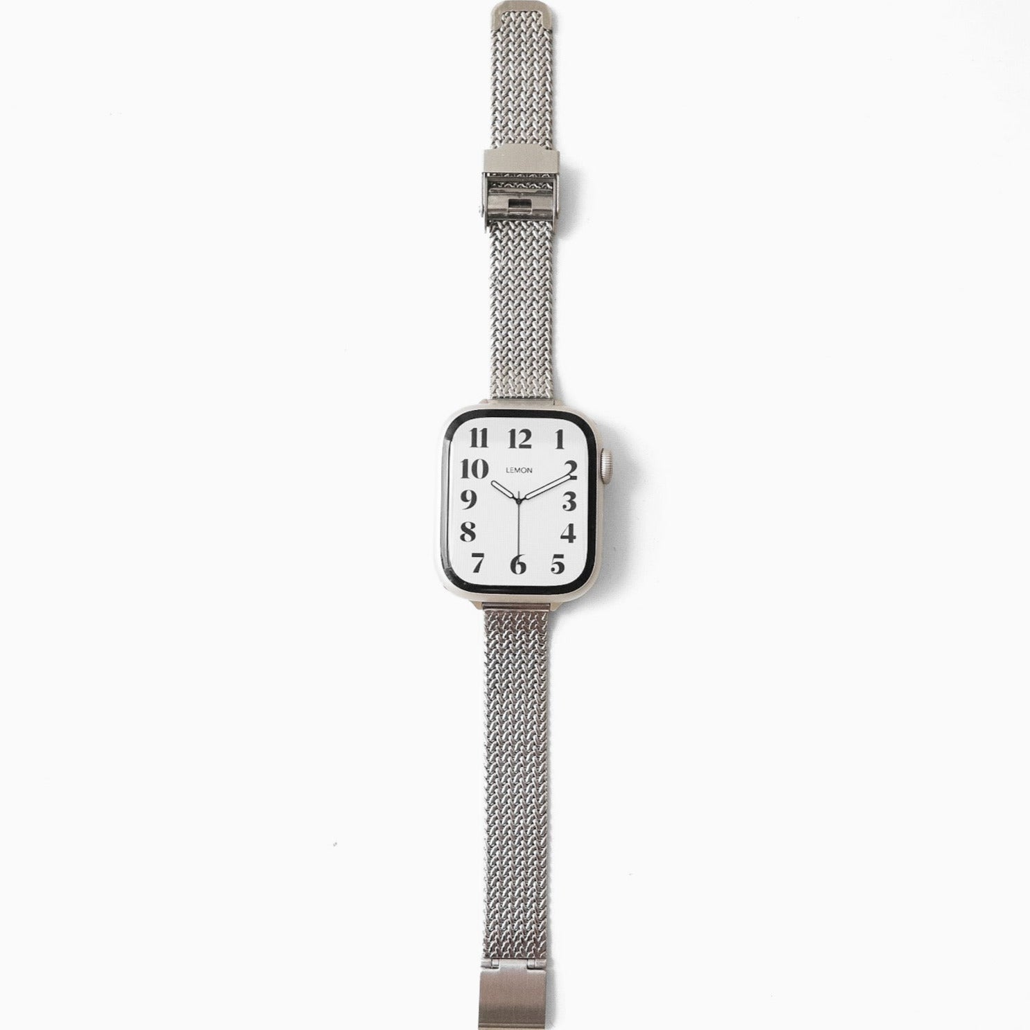 Silver watch with a mesh band on a white background